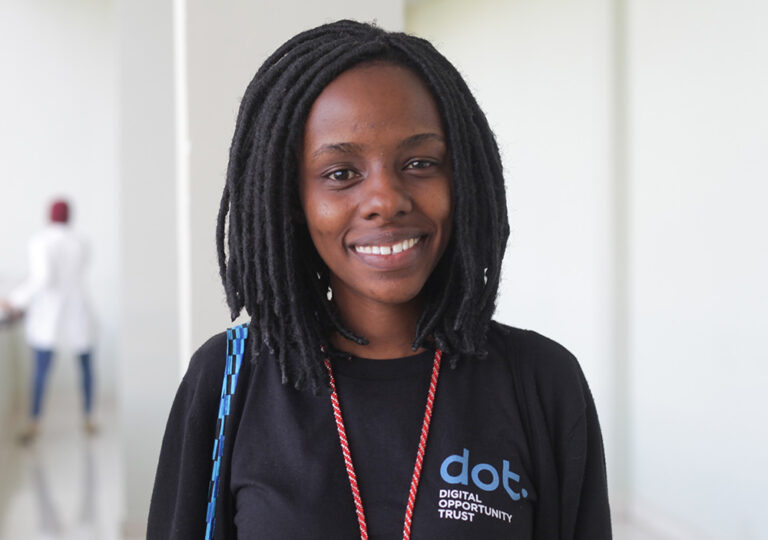 A photo of a young woman looking at the camera and smiling